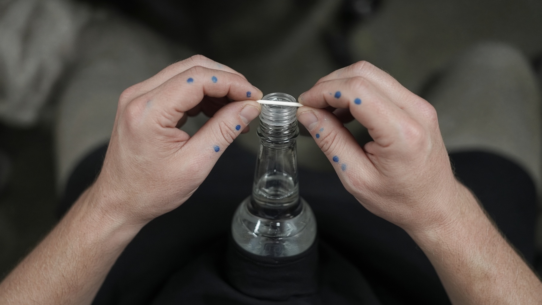 Unscrewing a bottle cap.